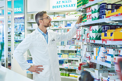 Buy stock photo Mature man, pharmacist and checking shelf with inventory for stock, medication or medical supplies at pharmacy. Male person or healthcare employee looking at drugs or pharmaceuticals at dispensary