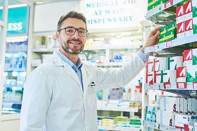 Buy stock photo Shot of a mature pharmacist working in a pharmacy
