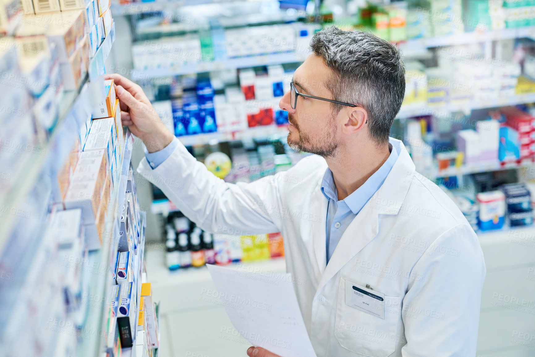 Buy stock photo Shot of a mature pharmacist working in a pharmacy