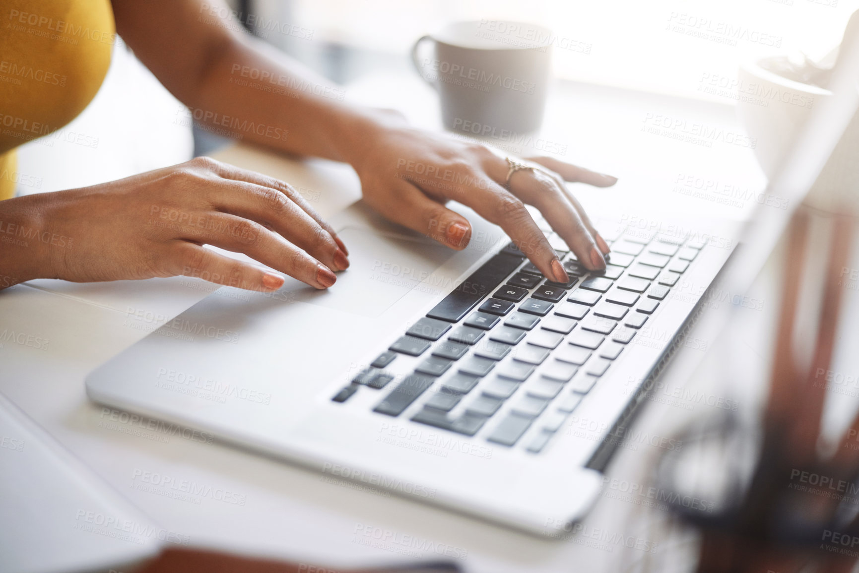 Buy stock photo Closeup shot of an unrecognizable female designer using a laptop in her home office