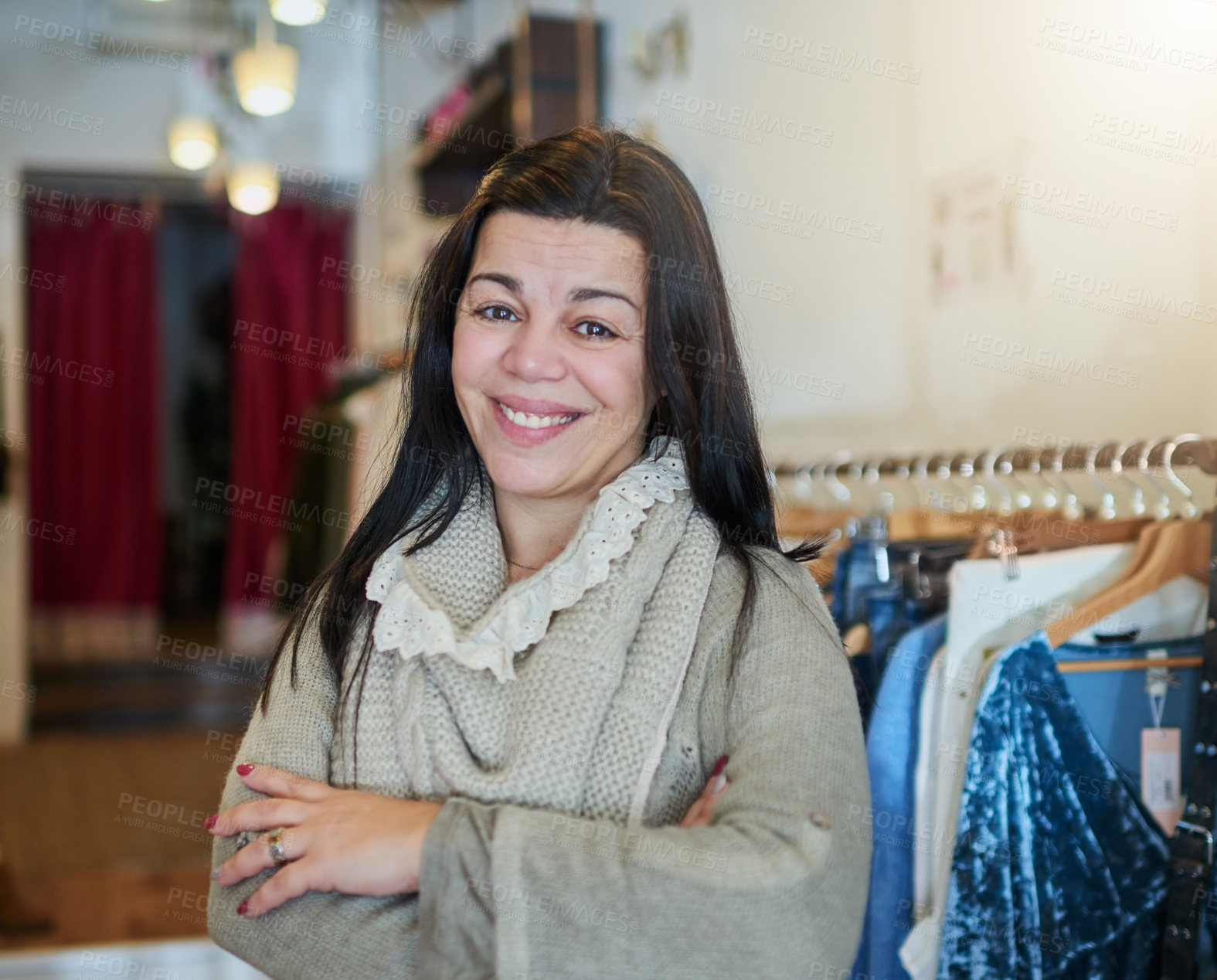 Buy stock photo Cropped portrait of an attractive mature female entrepreneur standing with her arms crossed in her self-owned boutique