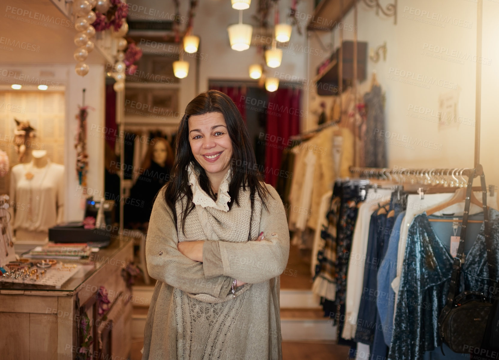 Buy stock photo Cropped portrait of an attractive mature female entrepreneur standing with her arms crossed in her self-owned boutique