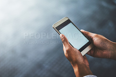 Buy stock photo Cropped shot of a woman using a cellphone in a gym