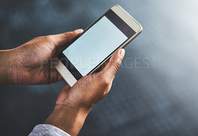 Buy stock photo Cropped shot of a woman using a cellphone in a gym