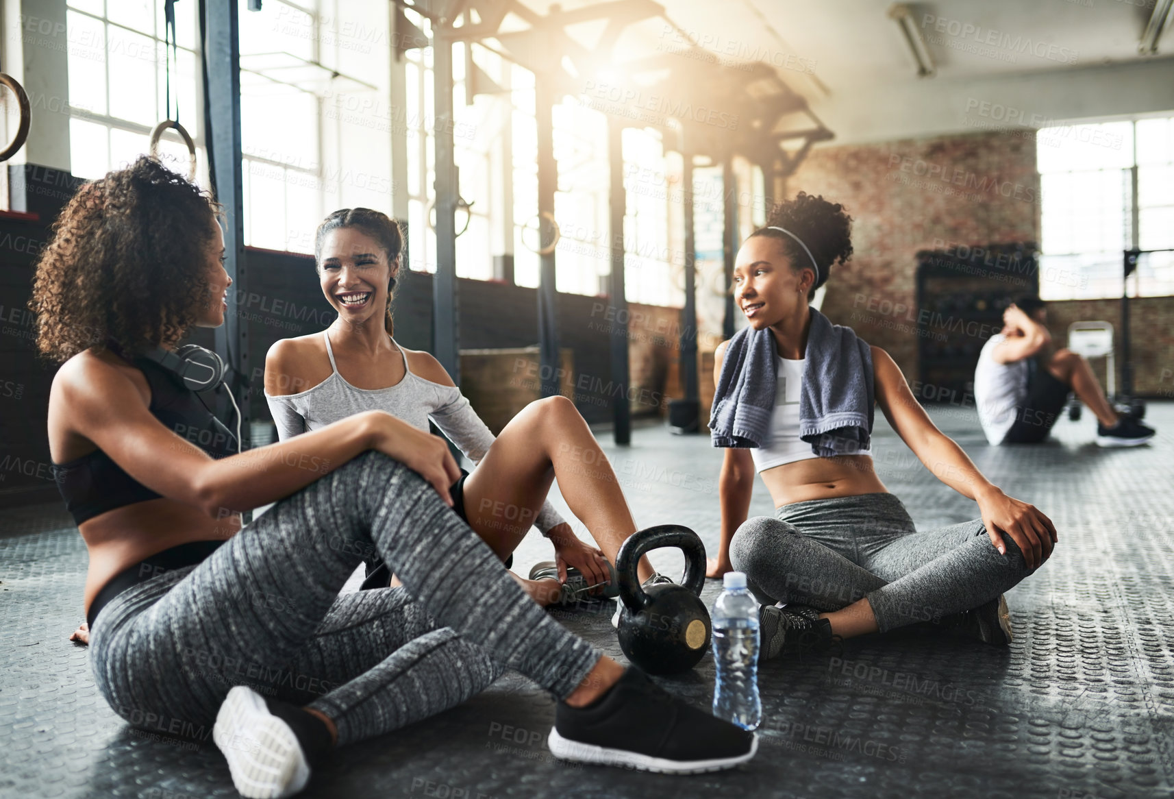 Buy stock photo Shot of a group of happy young women taking a break together at the gym