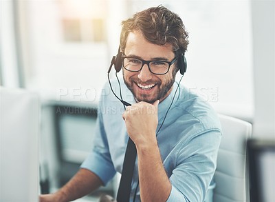 Buy stock photo Shot of a happy young man working in a call center