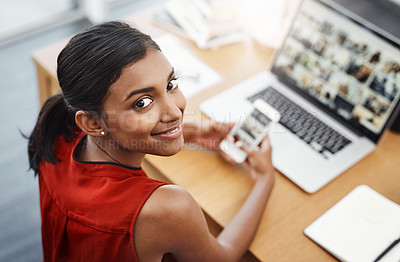 Buy stock photo Laptop, phone and portrait of a business woman with website for media, research and creative work or blog. Happy Indian female entrepreneur at a desk with a smartphone and internet while typing