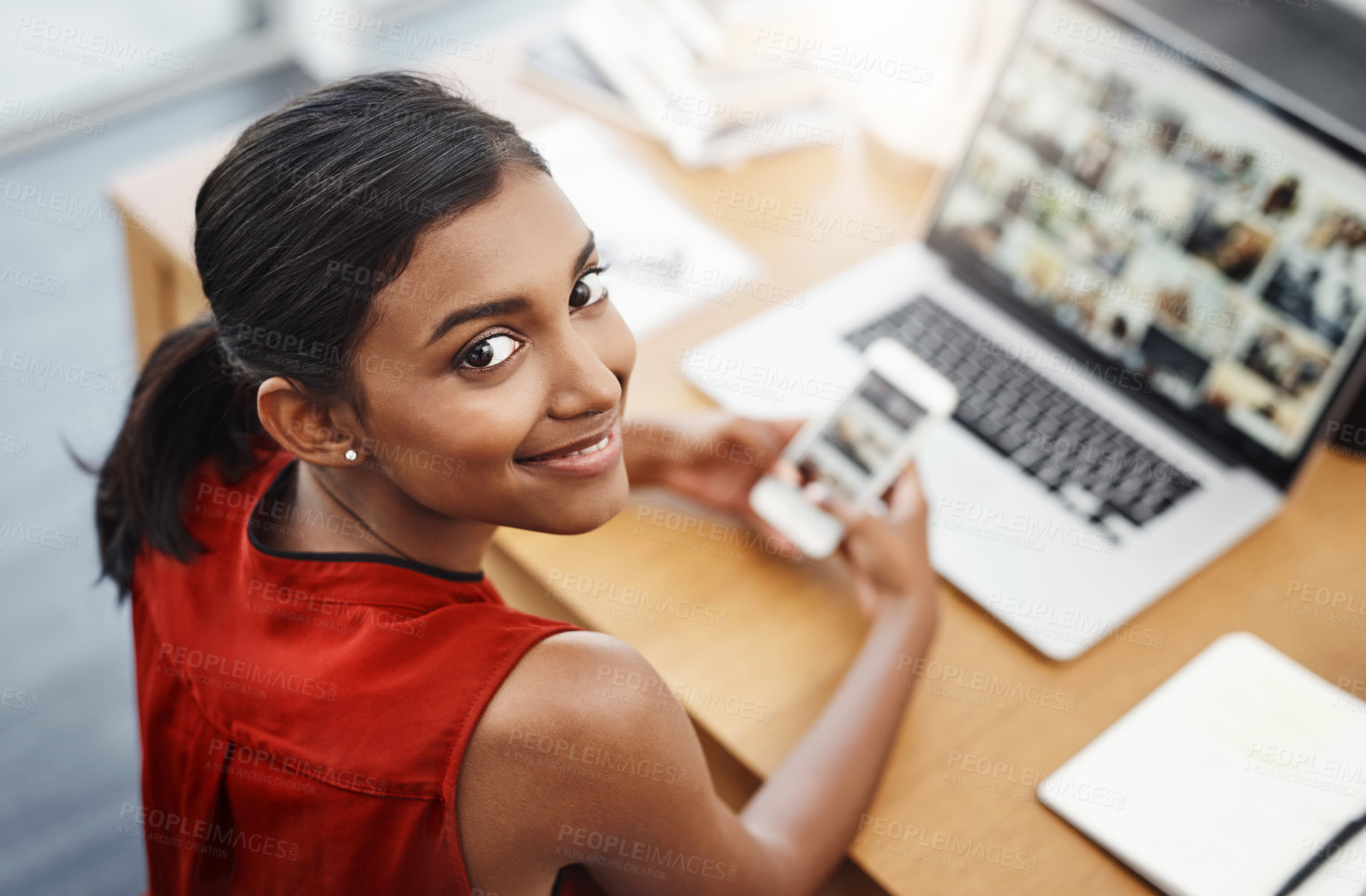 Buy stock photo Laptop, phone and portrait of a business woman with website for media, research and creative work or blog. Happy Indian female entrepreneur at a desk with a smartphone and internet while typing