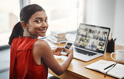 Buy stock photo Business woman, portrait and smile with a phone and laptop at desk for media, research and creative work or blog. Happy Indian female entrepreneur with a smartphone and internet for communication