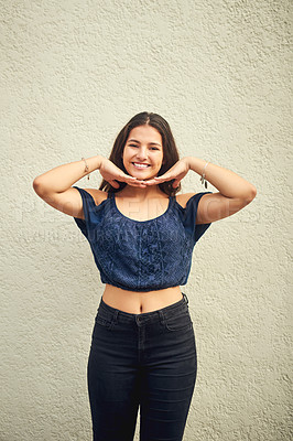 Buy stock photo Portrait of a happy teenage girl posing against a wall outside