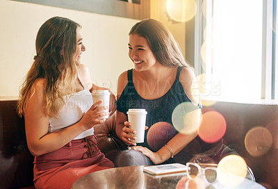 Buy stock photo Cropped shot of two attractive young women chilling in their local cafe