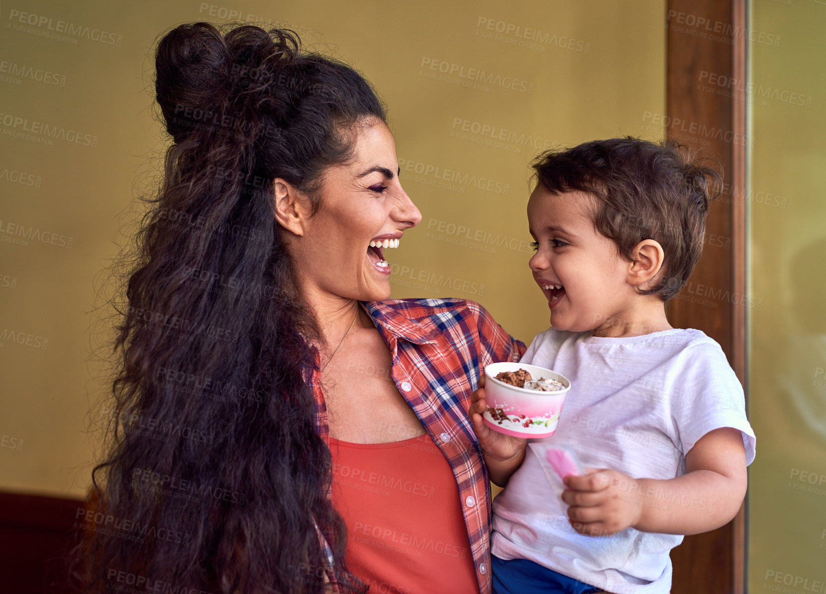 Buy stock photo Cropped shot of an attractive young woman and her young son at an ice cream shop