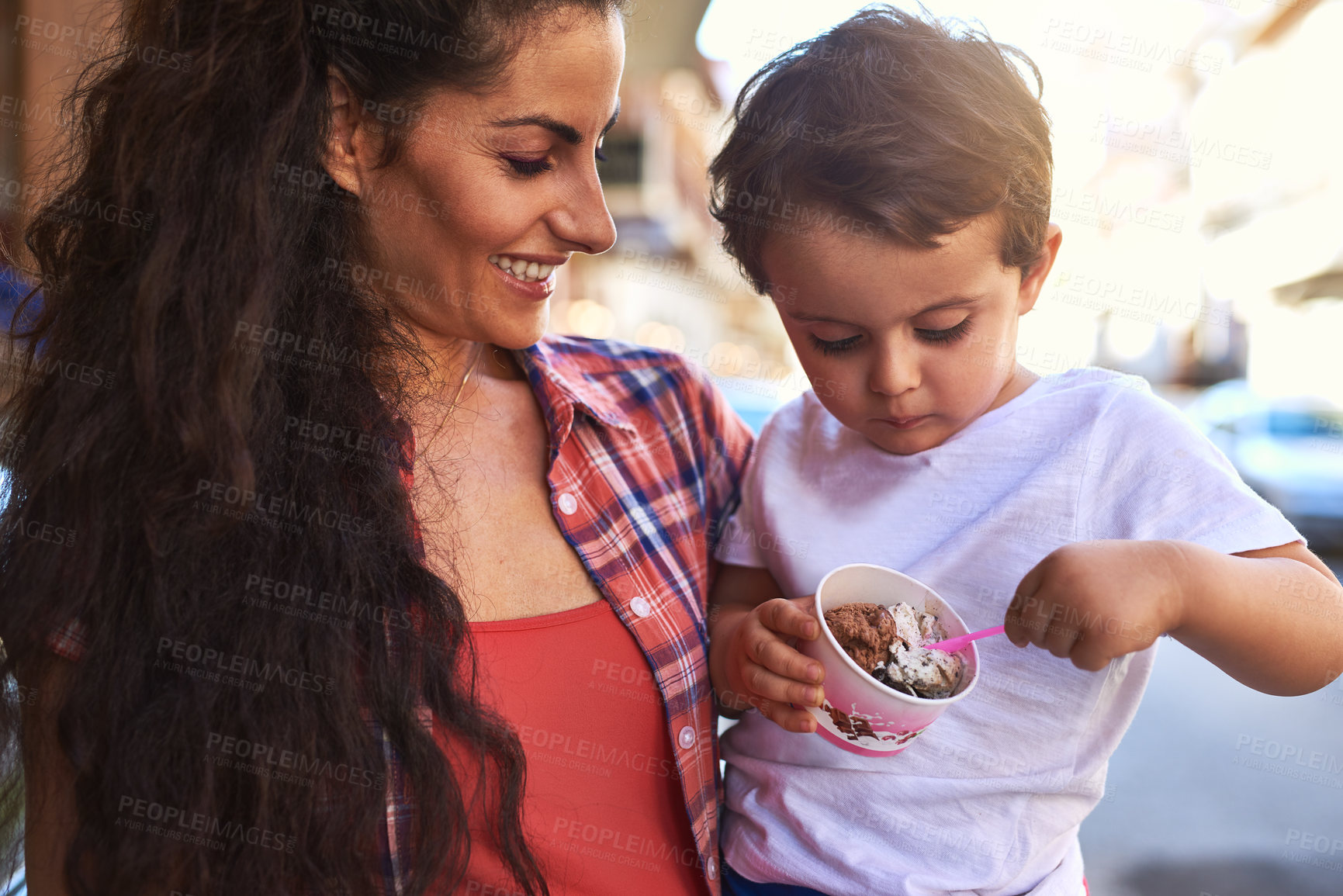 Buy stock photo Cropped shot of an attractive young woman and her young son at an ice cream shop