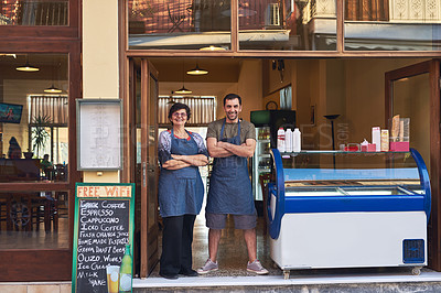 Buy stock photo Full length portrait of a mature woman and her adult son standing in the entrance way to their family ice cream shop
