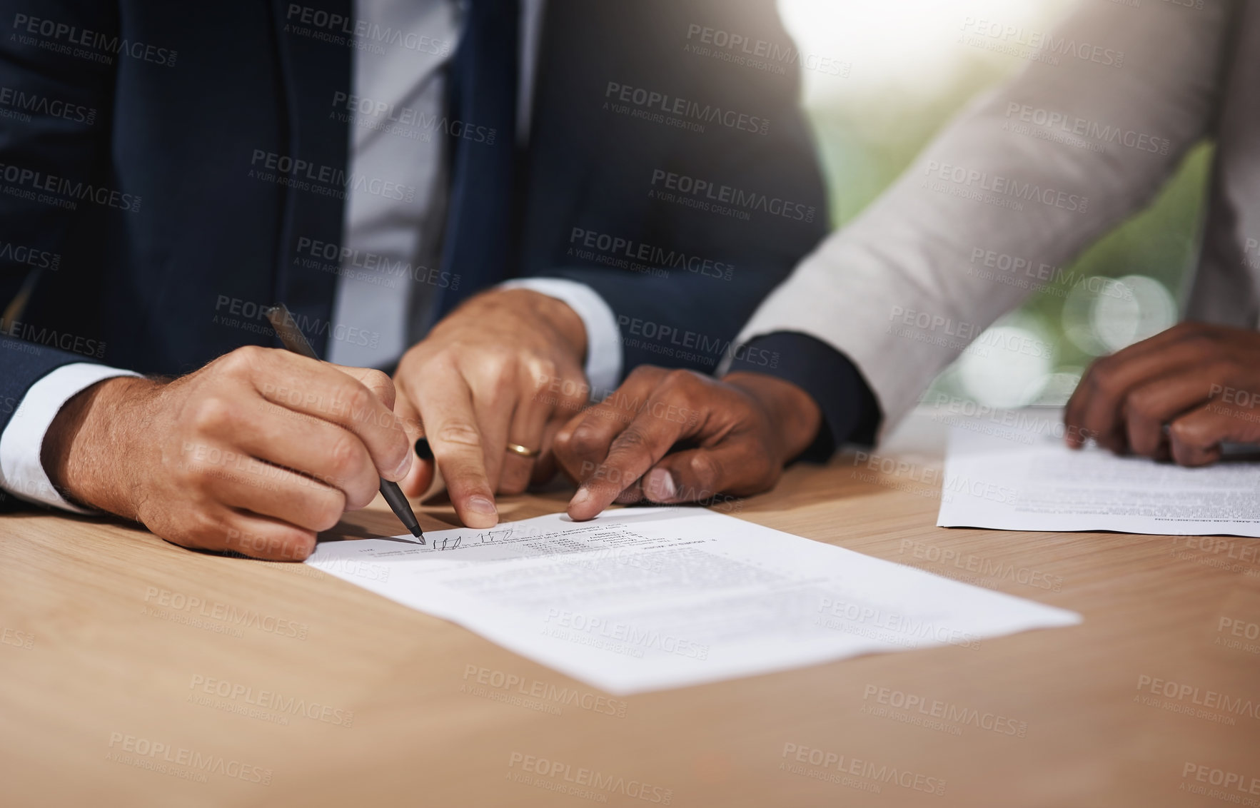 Buy stock photo Closeup shot of two unrecognizable businesspeople going through paperwork in an office