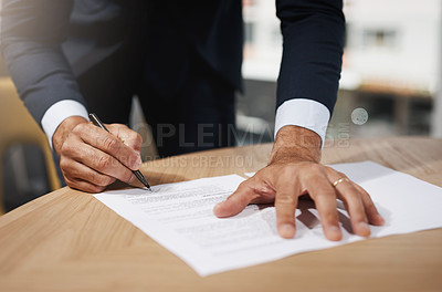 Buy stock photo Closeup shot of an unrecognizable businessman going through paperwork in an office