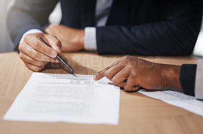 Buy stock photo Closeup shot of two unrecognizable businesspeople going through paperwork in an office