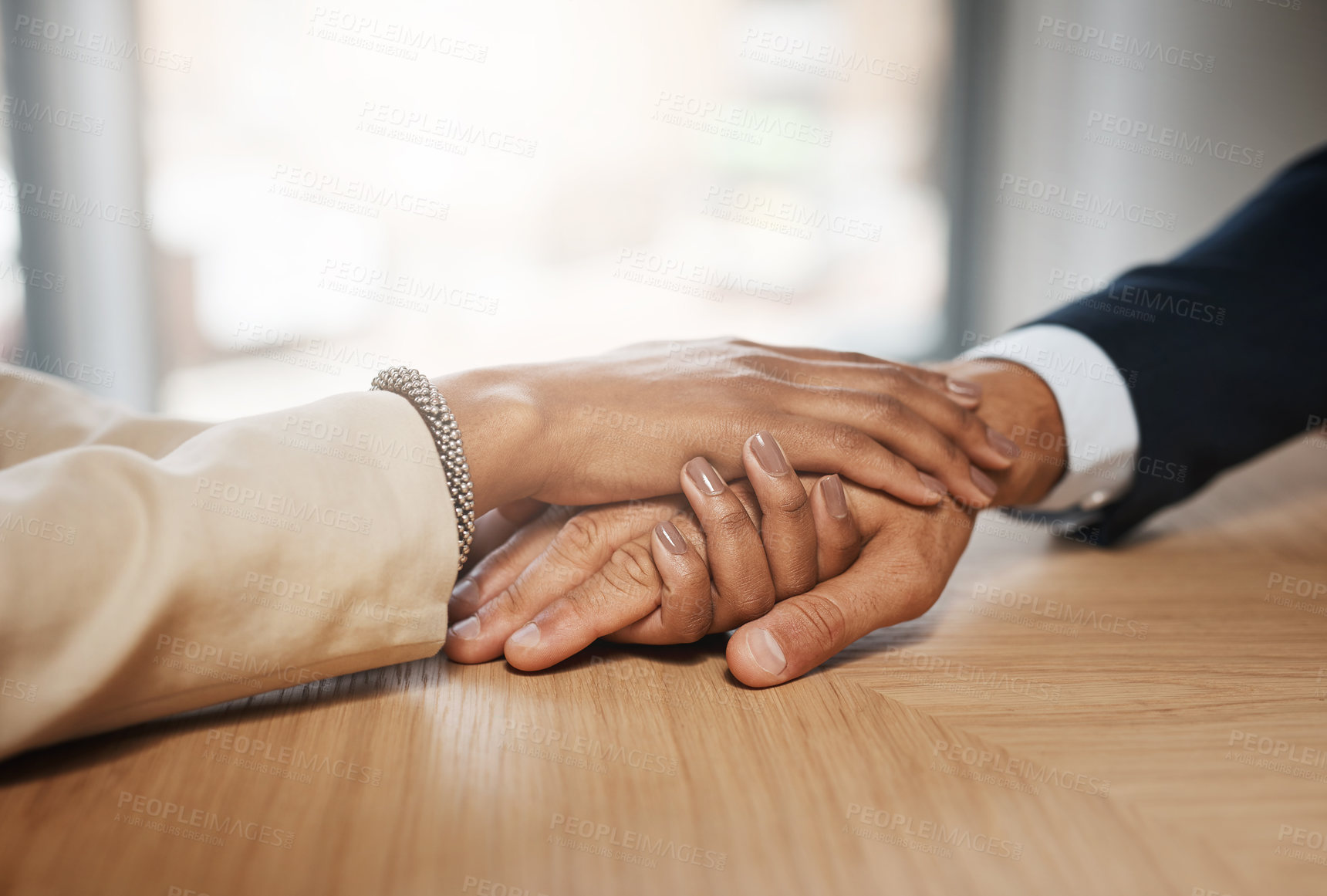 Buy stock photo Closeup shot of two unrecognizable businesspeople holding hands in an office