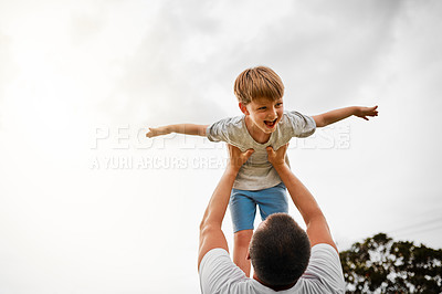 Buy stock photo Cropped shot of a mature man lifting his young son high into the air outside