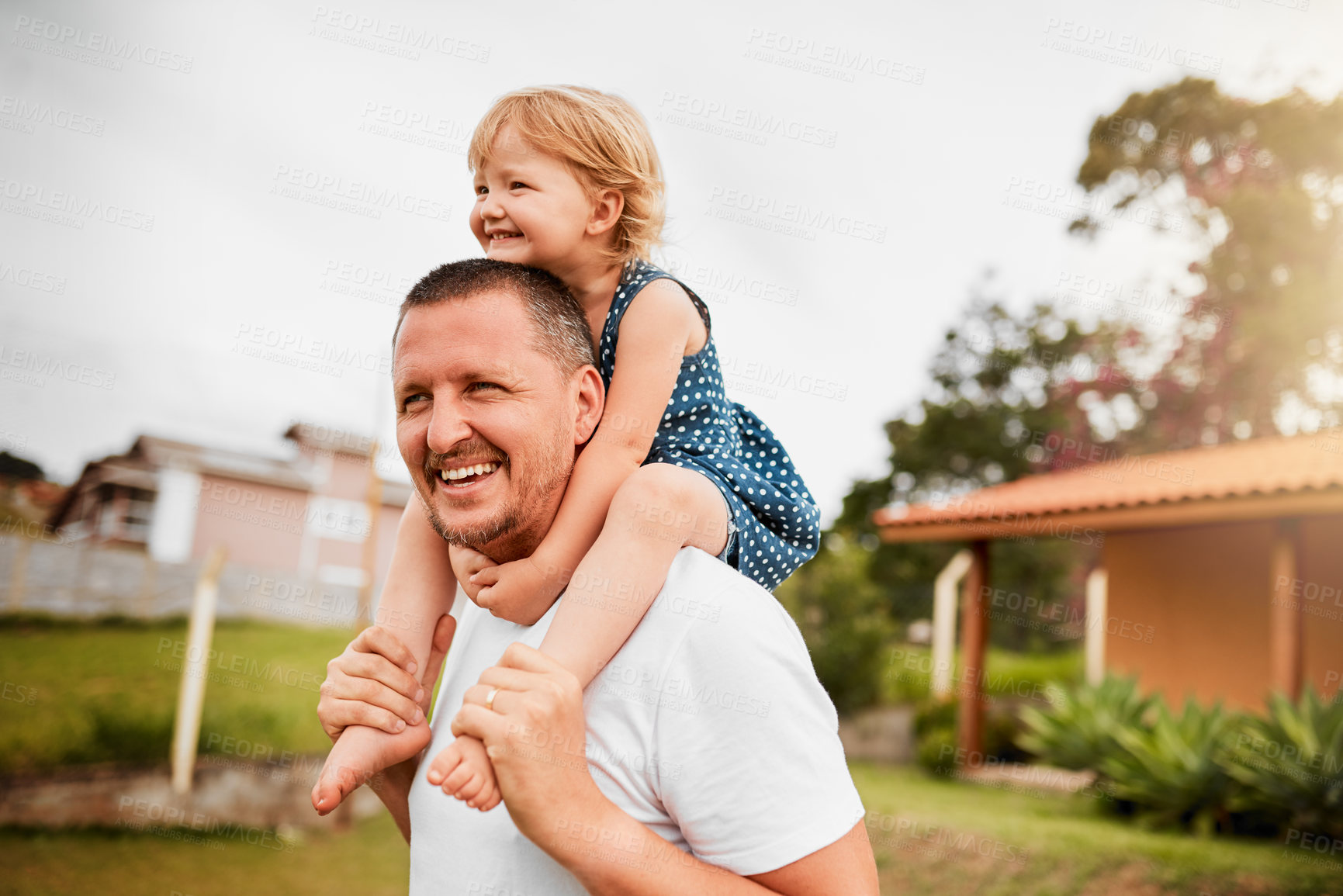 Buy stock photo Cropped shot of a mature man carrying his young daughter on his shoulders outside