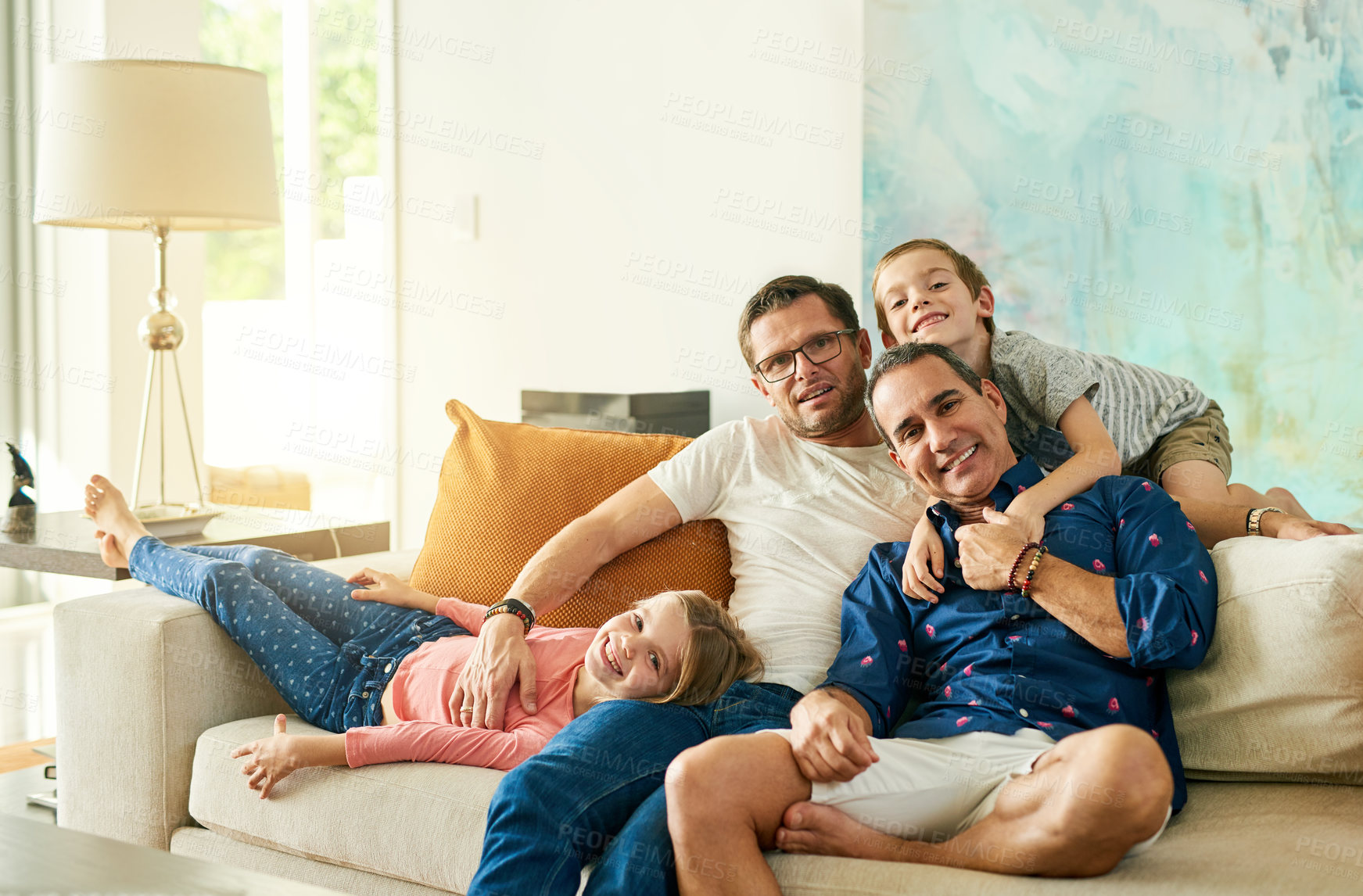 Buy stock photo Cropped portrait of an affectionate family of four on the sofa at home