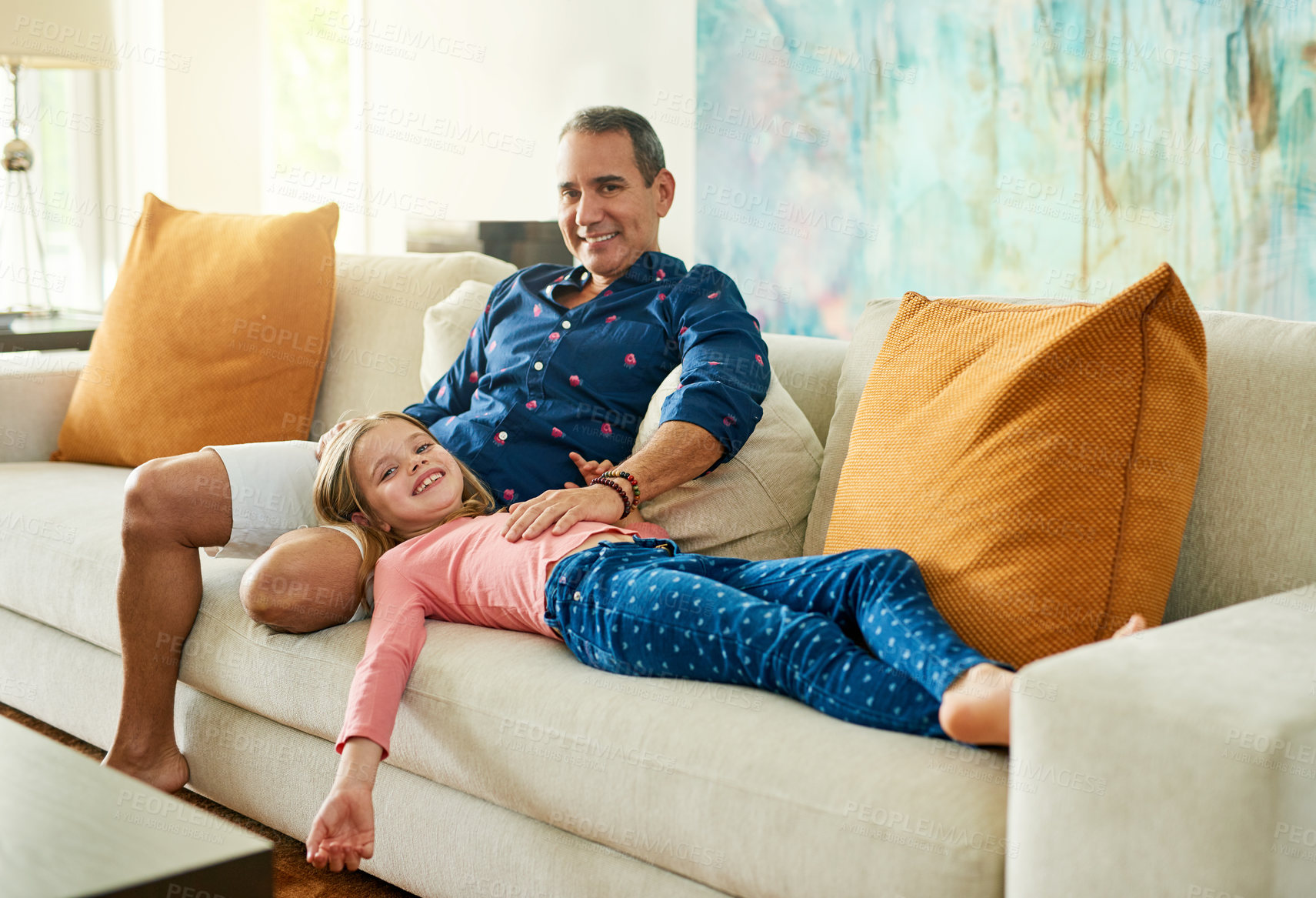 Buy stock photo Full length portrait of a mature man and his daughter on the sofa at home