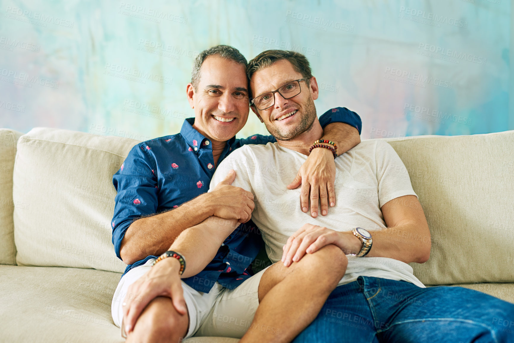 Buy stock photo Cropped portrait of an affectionate mature couple on the sofa at home