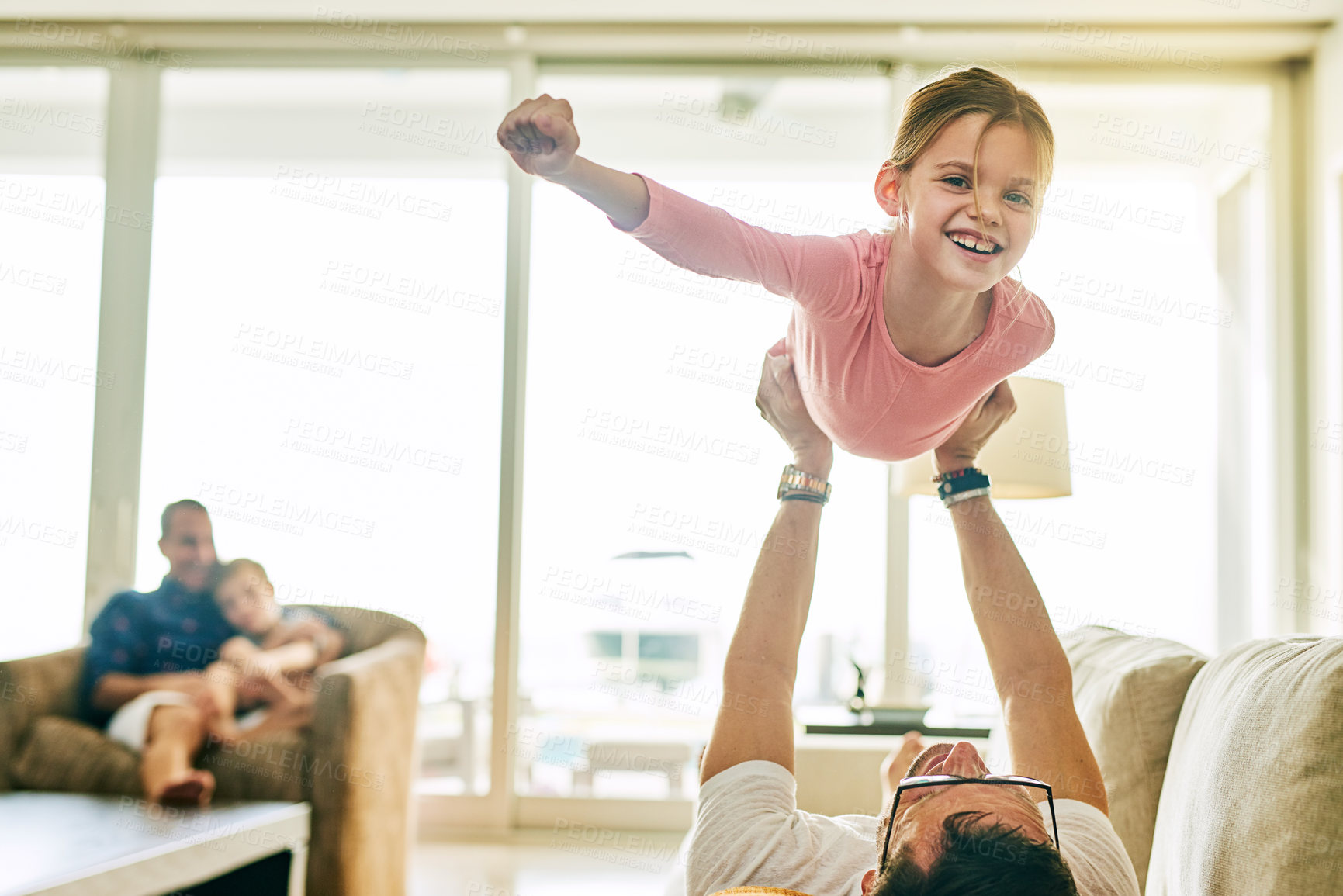Buy stock photo Cropped portrait of an adorable little girl playing with her father at home
