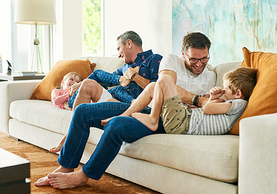 Buy stock photo Gay parents, family fun and living room with dads and kids together with laugh and tickle. Parent love, bonding and care with father, papa and children in a home with a smile and lgbt people in house