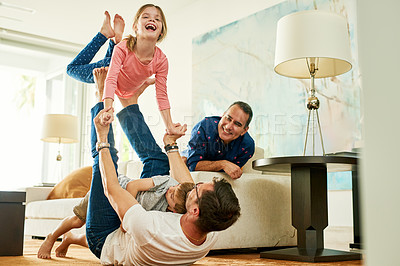 Buy stock photo Cropped shot of an adorable little girl playing with her father at home