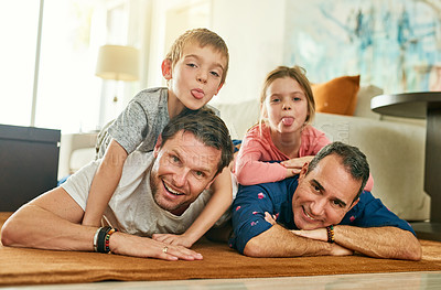 Buy stock photo Gay parents, family and kids in portrait with love, care and funny face on living room floor at home. Happy father and children for weekend, bonding and relax together with tongue out, fun and games