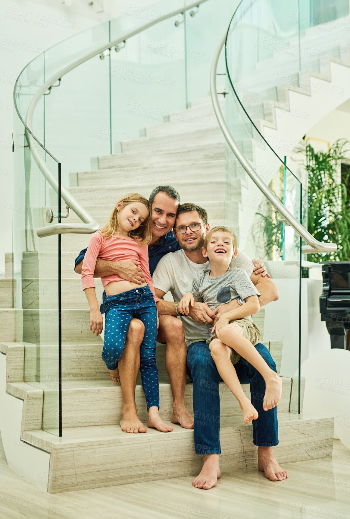 Buy stock photo Gay parents, dad and children on home staircase for real estate, moving or holiday house with bonding together. Happy men, family and kids with hug, love and relax in portrait in Finland, Europe