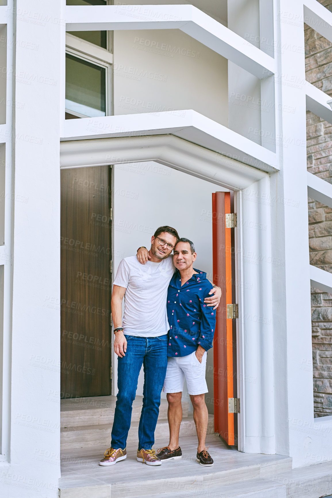Buy stock photo Full length portrait of an affectionate mature couple standing in the doorway to their home