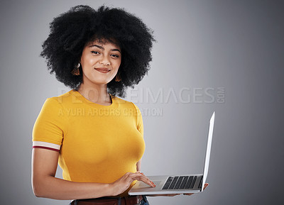 Buy stock photo Black woman, laptop and portrait in studio for copywriting article on hair care tips, advice and growth. Curly girl or copywriter typing on computer with natural texture or style on gray background