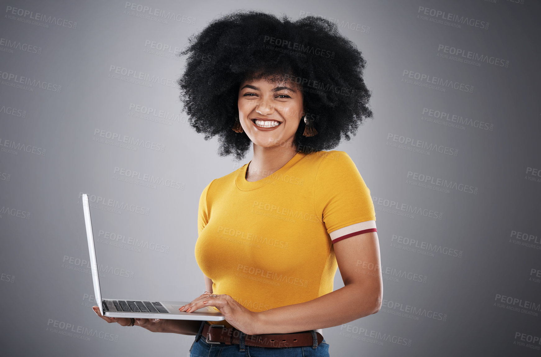 Buy stock photo African woman, computer and portrait in studio for copywriting article on hair care tips, advice and growth. Curly girl or copywriter typing on laptop with natural texture or style on gray background