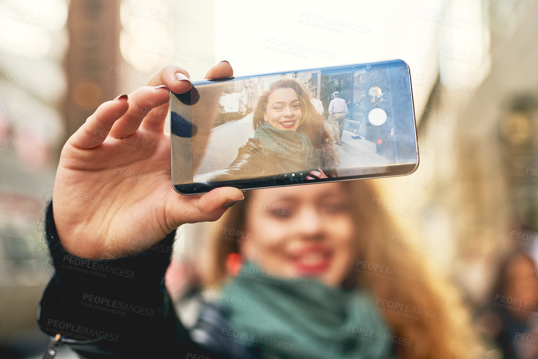 Buy stock photo Cropped shot of a young woman taking selfies while out in the city