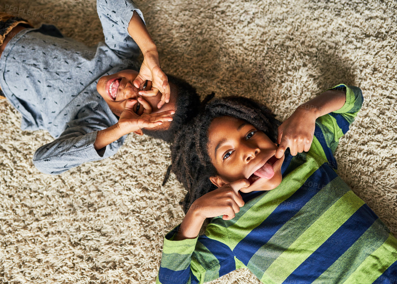 Buy stock photo High angle shot of two little boys pulling funny faces