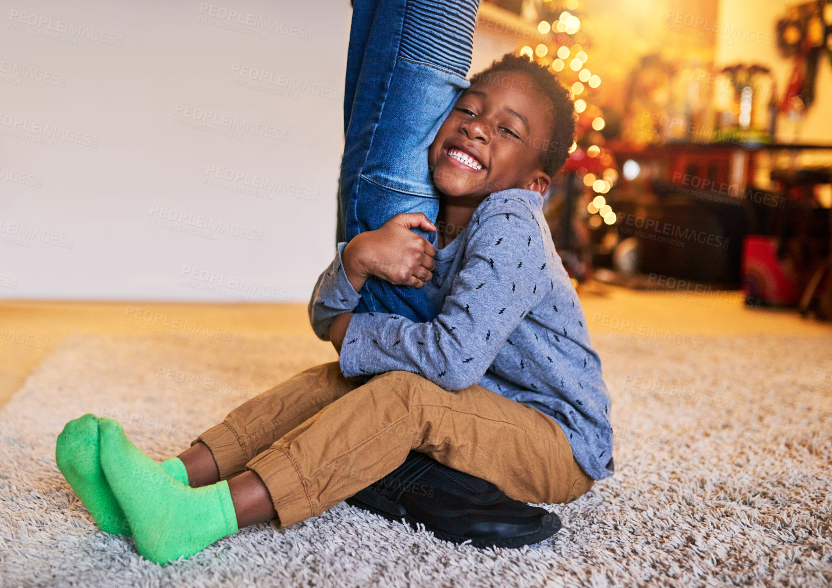 Buy stock photo Shot of a little boy holding on to his father's legs