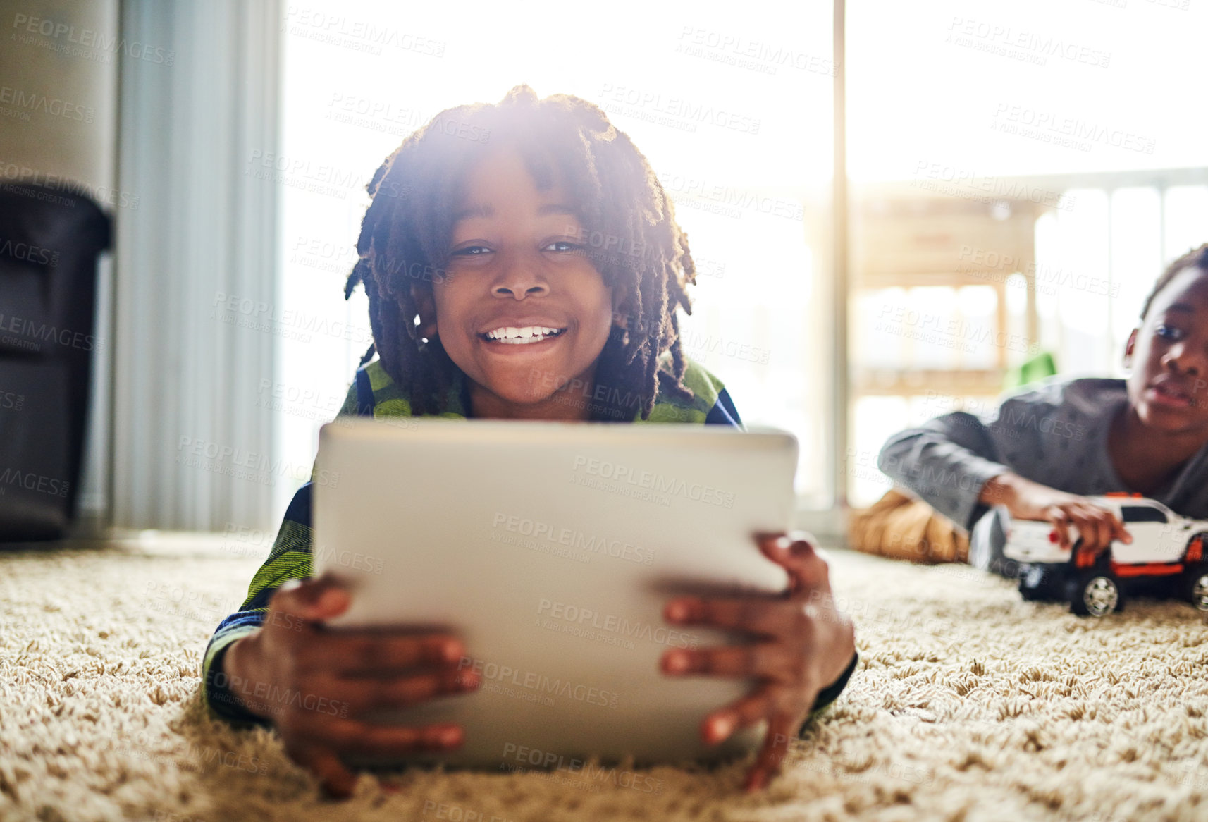 Buy stock photo Shot of a young boy using a digital tablet