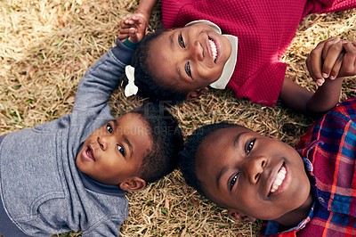 Buy stock photo Portrait of three adorable siblings having fun together outdoors