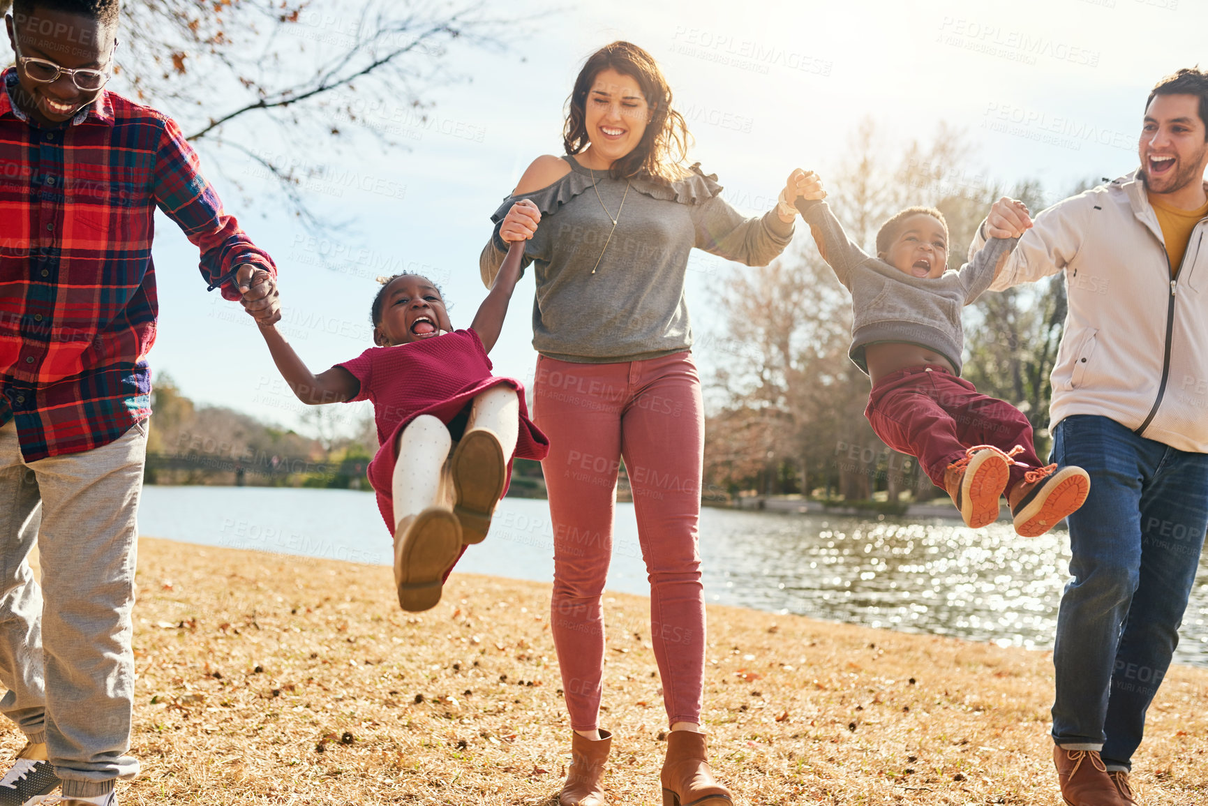 Buy stock photo Shot of a happy family having fun together outdoors