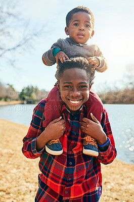 Buy stock photo Children, boys and shoulder carry with smile, portrait and field for fun and playing in park. Vacation, black family and siblings with bonding, happy and together for autumn holiday with confidence