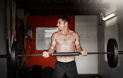 Buy stock photo Cropped shot of a handsome and muscular young man working out with a barbell in the gym