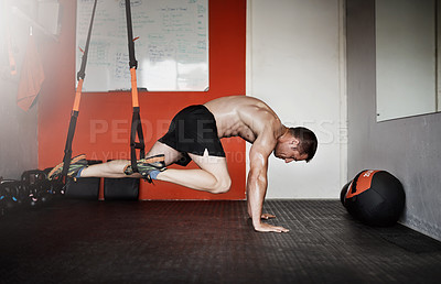 Buy stock photo Full length shot of a handsome and muscular young man working out in the gym