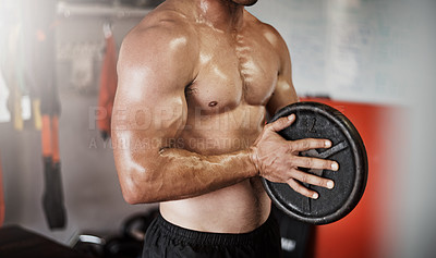 Buy stock photo Cropped shot of an unrecognizable muscular young man working out with a weight in the gym