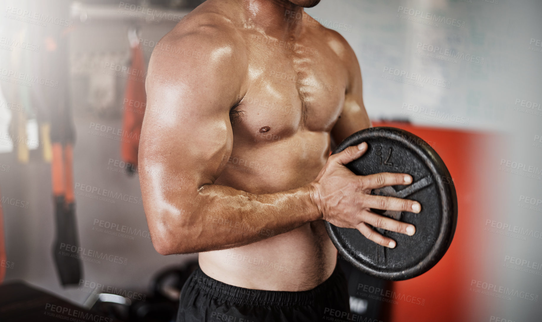 Buy stock photo Cropped shot of an unrecognizable muscular young man working out with a weight in the gym