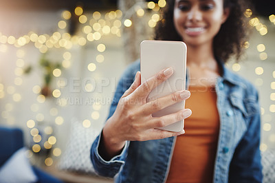 Buy stock photo Cropped shot of an unrecognizable woman using her cellphone