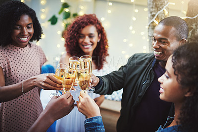 Buy stock photo Shot of a group of young friends making a toast