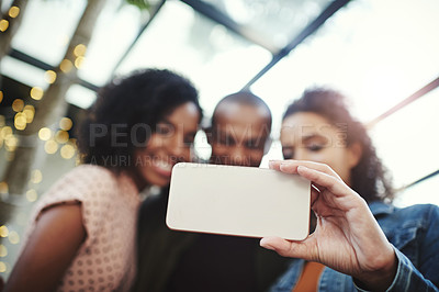 Buy stock photo Shot of a group of friends taking a selfie together on their night out