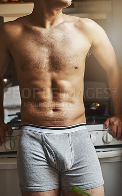 Buy stock photo Cropped shot of an unrecignizable shirtless man in the kitchen at home